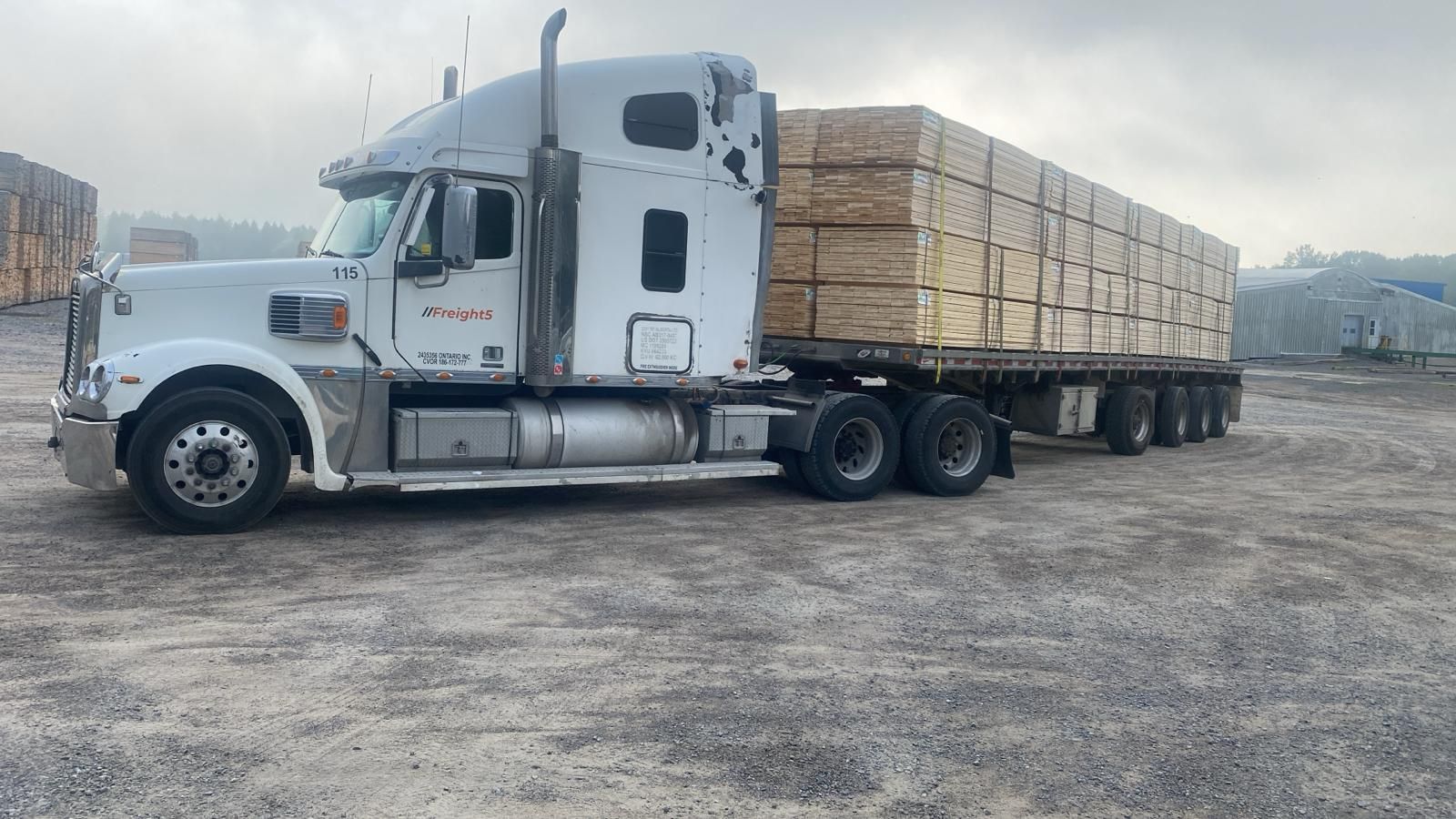Freight5 quad-axle flatbed trailer loaded with a lumber package