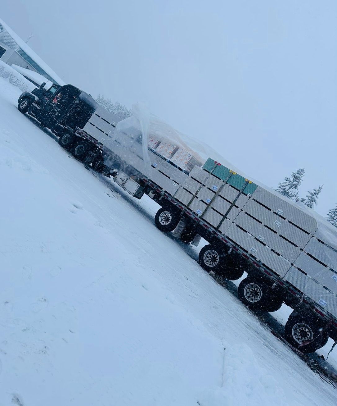 Freight5 flatbed trailer loaded and secured during an Ontario snowfall